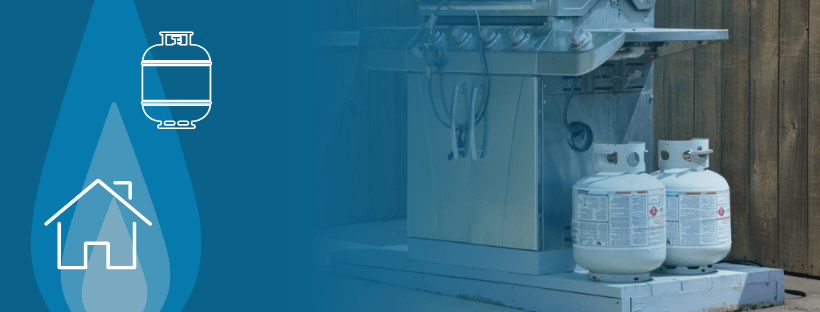 A gas cylinder and a gas bottle positioned beside a residential propane grill.
